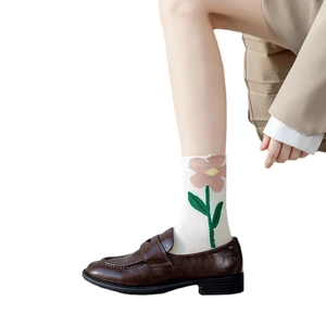 Women's cute cotton socks with pink floral embroidery paired with stylish loafers