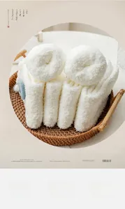 Detailed texture of thick white coral fleece winter socks with blue patch on a tray