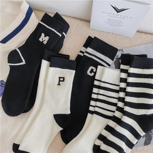 Winter thermal mid-calf socks with black and white stripes and embroidery in soft knit
