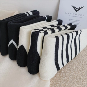Assorted black and white striped thermal crew socks in thick cotton knit fabric