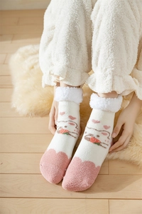 Detail of coral fleece thick socks featuring a cute cat design and soft plush cuff