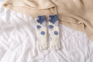 Detail showing plush coral fleece texture of blue cat paw winter thermal socks