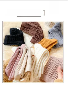 Detailed view of thick cable knit texture on soft wool blend winter socks in multiple colors