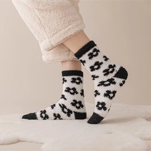 Soft black and white coral fleece thermal socks featuring stylish patterns and plush texture