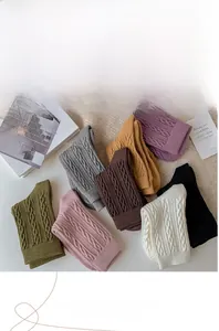 Detailed cable knit texture of thick wool socks in eight various solid colors for winter