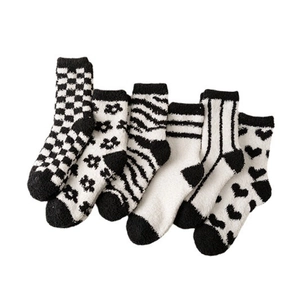 Set of 6 pairs of black and white coral fleece socks in checkered and striped patterns