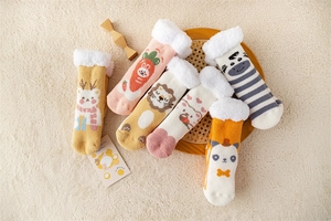 Detail of assorted coral fleece socks with cute cartoon animal patterns and plush lining
