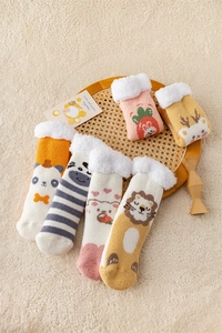 Close-up of six pairs of cartoon coral fleece thermal socks with thick plush cuffs