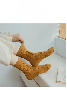 Detail of ginger yellow thick cable-knit wool socks made of premium long-staple cotton