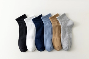 Flat lay of six pairs of breathable cotton crew socks in neutral minimalist colors