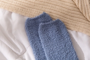 Detail of blue coral fleece cat paw socks with soft fuzzy texture for winter comfort