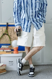 Men's breathable blue striped shirt and white shorts outfit with athletic details
