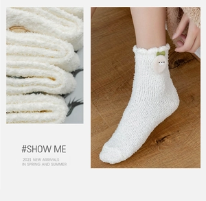Close-up of soft white coral fleece socks featuring a cute 3D cartoon chick detail