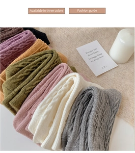 Close-up of thick cable knit wool socks in various vintage colors with soft texture