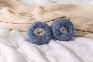 Detailed close-up of blue coral fleece socks with fluffy feather yarn texture for winter