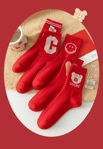 Detail of red crew socks set with various cute embroidery patterns for New Year