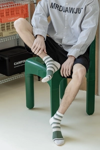 Close-up of men's striped breathable cotton crew socks in white, green and blue