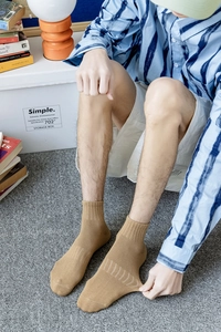 Close-up of khaki cotton crew sock showing high elasticity and ribbed cuff detail