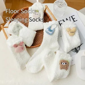 Cozy white coral fleece socks with cute cartoon 3D animal charms in a woven basket