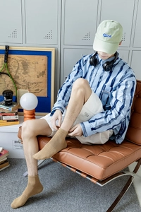 Detail of khaki crew socks with ribbed cuffs paired with casual campus style outfit