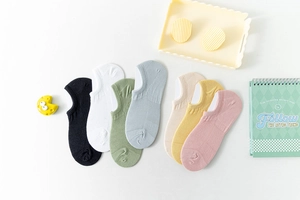 Flat lay display of 7-color cotton invisible socks set with macaron tones and accessories