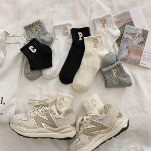 Detail view of premium combed cotton socks with P letter embroidery and ribbed texture