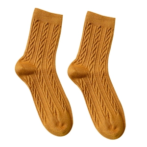 Thick ginger yellow cable-knit wool socks for women providing warmth in winter