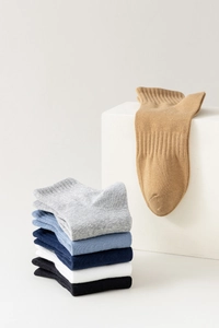 Detailed view of ribbed cuffs on multiple solid color cotton blend ankle socks