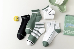 Detail of vintage athletic cotton socks featuring letter embroidery and ribbed texture