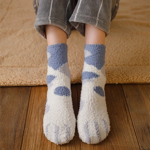 Blue and white coral fleece cat claw socks for winter home warmth on wooden floor