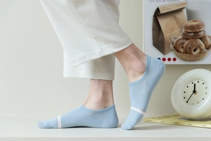 Detail of light blue low-cut cotton sock with white contrast stripe on toe and ribbed cuff