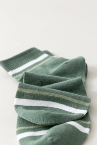 Close-up of dark green striped cotton ankle socks with soft knitted texture and pattern