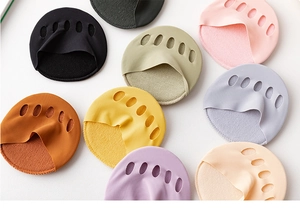 Close-up of colorful five-toe forefoot pads for high heels in various soft fabric shades
