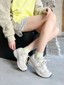 Detail of H letter embroidery on cotton sport socks paired with vintage sneakers