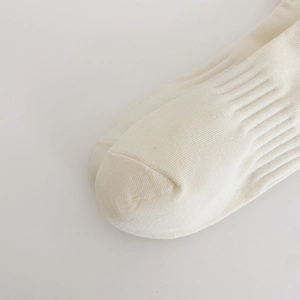 Detail of premium combed cotton toe seam and ribbed texture on beige low cut socks