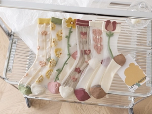 Detailed embroidery of tulips and flowers on sheer mesh socks in various pastel colors