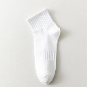 Single white mid-calf cotton sports sock with premium ribbed texture on leather surface