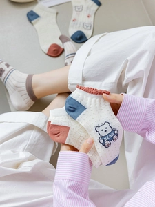 Detail of bamboo fiber mesh socks with bear pattern and frilly cuffs for summer