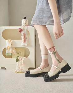 Detail of sheer tulip embroidered mesh crew socks with vintage Mary Jane shoes