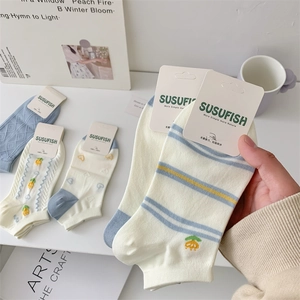 Close-up of cotton low cut socks with embroidery in blue and white floral patterns