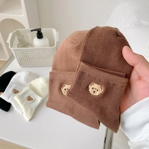 Detailed view of knitted cotton socks with cute bear embroidery and ribbed texture