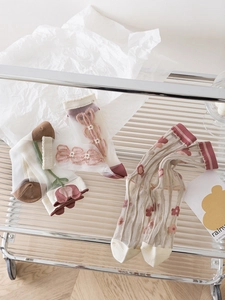 Detailed view of sheer floral tulle socks with delicate embroidery and lace petals
