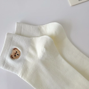 White cotton ankle socks featuring a detailed brown bear embroidery on the cuff