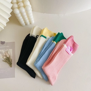 Close-up of five pairs of colorful ribbed cotton mid-tube socks with heart embroidery