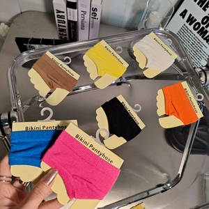 Multi-colored bikini pantyhose set with vibrant options on yellow card packaging