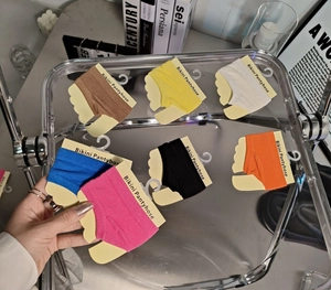 Detailed view of colorful bikini pantyhose set in various vibrant retail packaging