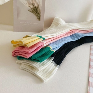 Detail showing ribbed knit cotton socks in pastel colors with contrasting striped cuffs