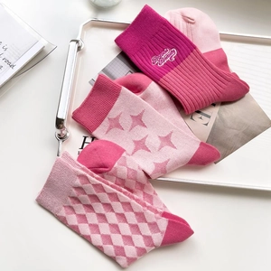 Detailed close-up of pink cotton crew socks featuring diamond patterns and star prints