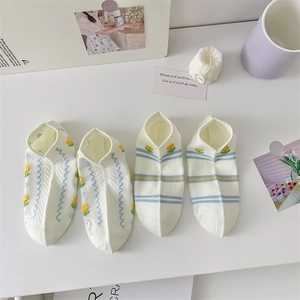Close-up of four pairs of breathable cotton low cut socks with floral embroidery details