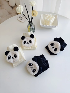 Detail of 3D plush panda socks with ribbed cotton texture and cute character accents